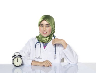 Young doctor with hijab. happy face expression siiting in front laptop ideal for stress management concept
