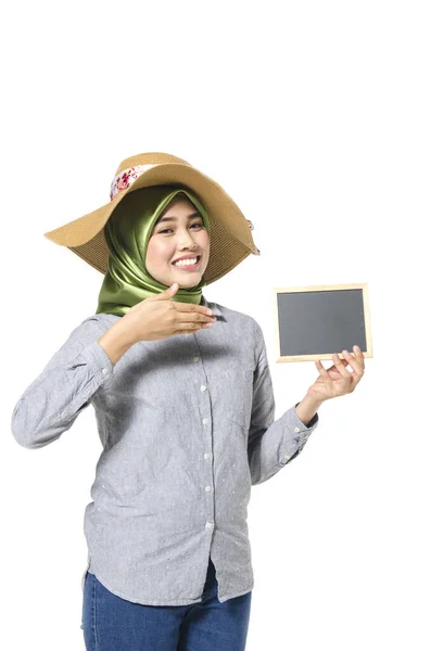 Schöne Dame mit Hijab steht und hält leere Kreidetafel für Text. — Stockfoto