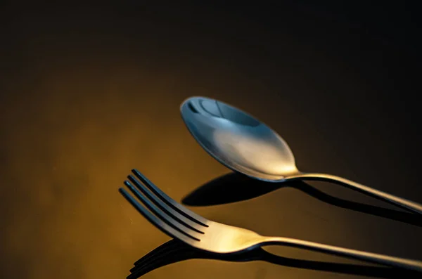 Tenedor y cuchara de plata sobre fondo oscuro — Foto de Stock