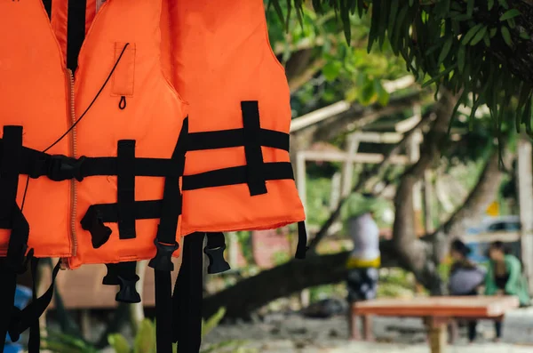 Close-up group of Life jacket or life vest hanging under the shelter at Pangkor Island, Malaysia