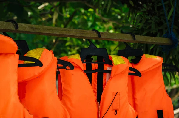 Close-up group of Life jacket or life vest hanging under the shelter at Pangkor Island, Malaysia