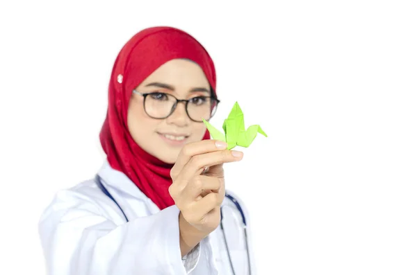 医学保健概念 年轻医生站在白色背景下手持折纸鸟的剪影 — 图库照片