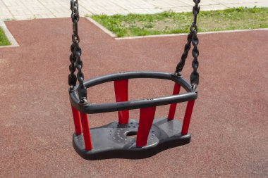 Çocuklar çocuk parkında sallanıyor. Zincirlerle sallan.