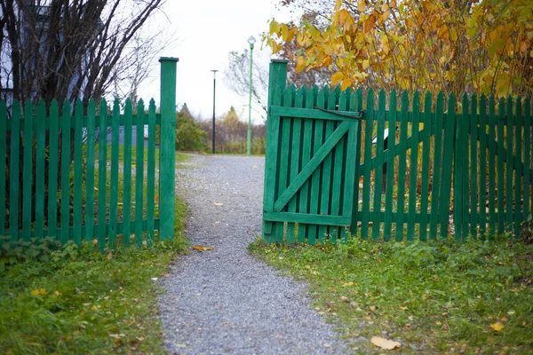 Wooden gate and fence. Entrance to the estate.