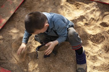Sokakta oynayan bir çocuk.