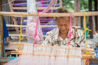 Nadun, Maha Sarakham, Tayland - 9 Mart 2018: Tayland 'da geleneksel Tayland kumaşı ören kadınlar. Nadun, Maha Sarakham, Tayland