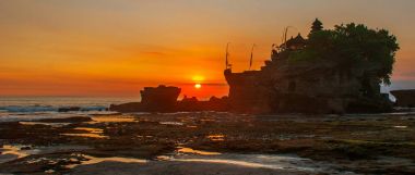 Tanah Lot water temple in Bali. Indonesia nature landscape. Sunset clipart