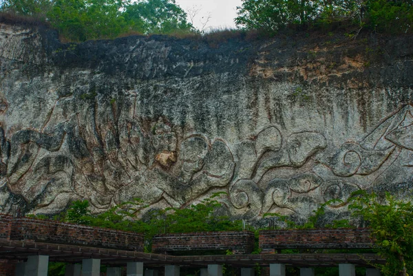 Garuda Wisnu Kencana Cultural Park. Wall of rock on which there is a relief image. Bali. Indonesia.