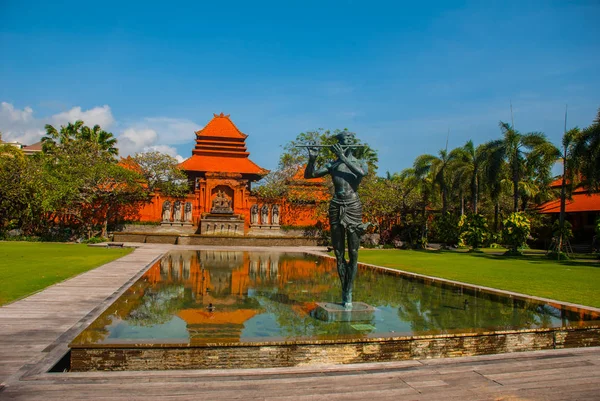 Beau bâtiment balinais avec fontaine et sculpteur jouant de la flûte. Tanjung Benoa. Nusa Dua, Bali — Photo