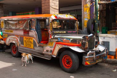 Jeepney parking on street in Manila, Philippines. clipart