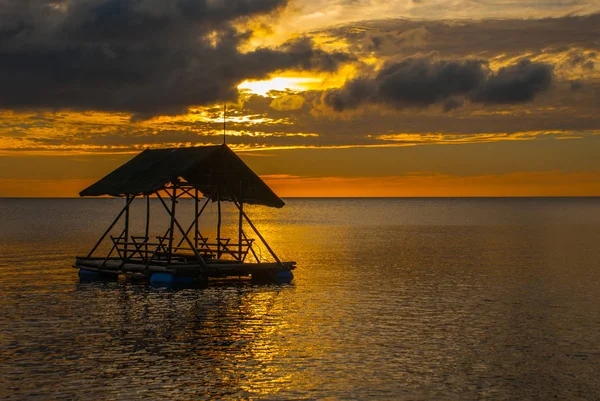 Bellissimo tramonto sulla spiaggia. Silhouette di padiglioni. Pandan, Panay, Filippine . — Foto Stock