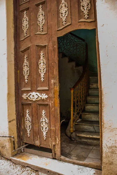 Old wooden open door close up on the street. Havana. Cuba
