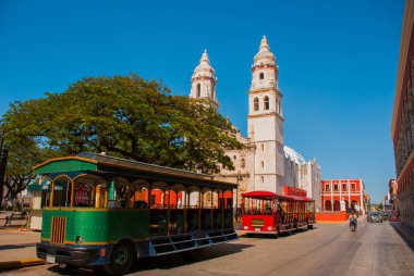Campeche, Mexico: Independence Plaza, tourist trains and cathedral on the opposite side of the square. Old Town of San Francisco de Campeche clipart