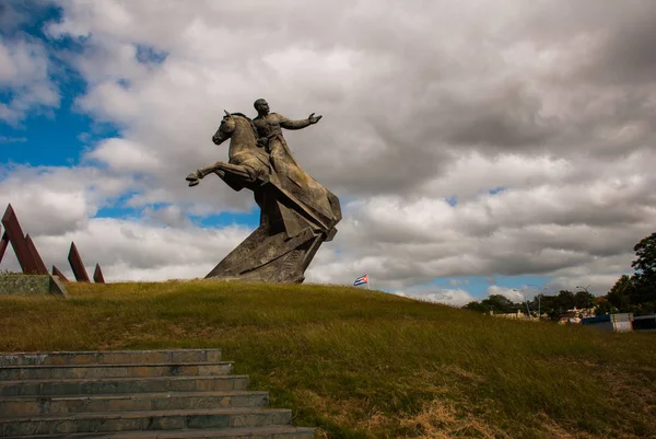 SANTIAGO, CUBA: Flag of Cuba. Antonio Maceo Monument in Santiago de Cuba. General Maceo was a famous guerilla independence leader. The sculpture is located at Revolution Square