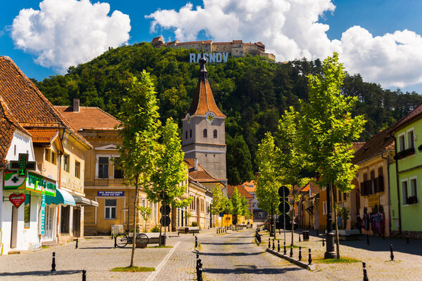 Rasnov, Romania: Scenic view on central street and Rasnov fortress on the top of hill. Location place: Brasov County, Transylvania, Romania.