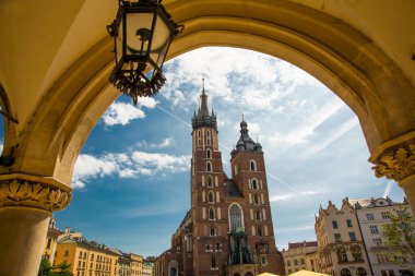 Church of St. Mary and the Cloth Hall in the main Market Square -Rynek Glowny in the city of Krakow in Poland.
