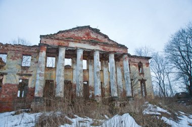 LENINGRAD REGION, RUSSIA - MARCH 9, 2014: view of the destroyed old buildings on the territory of the Blumentrostov and von Gersdorff estate in Kummolovo in cloudy weather