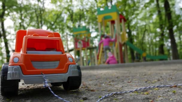 Camión de juguete en el patio de recreo — Vídeos de Stock