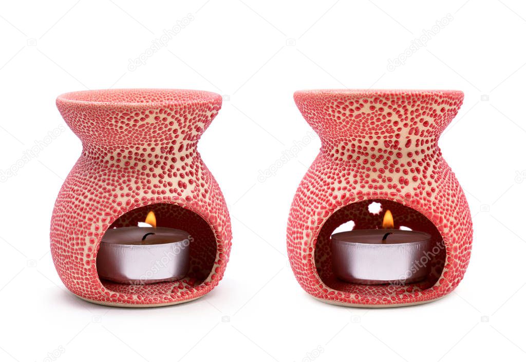Aroma lamp with a lit candle isolated on a white background