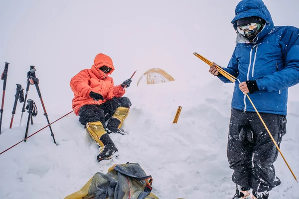 alpine climber men in heavy storm in mountains