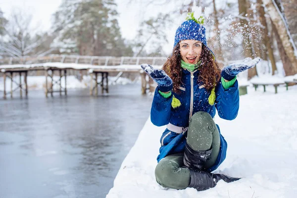 Молодая женщина наслаждается зимой в снежном парке — стоковое фото