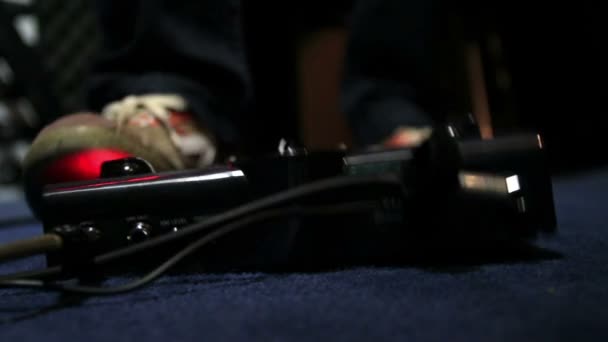 Cinemagraph of guitarist presses with his foot on the effects pedal — Stock Video