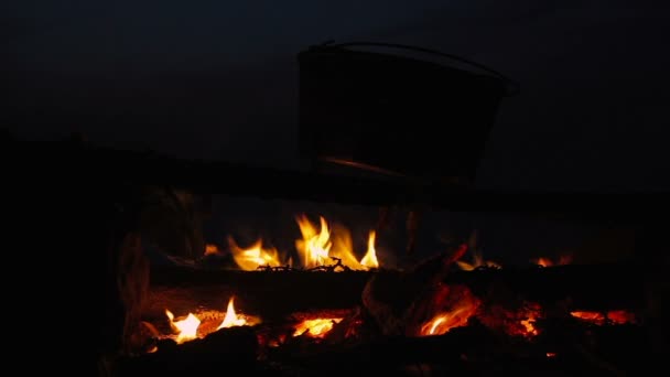 Cinemagraph van het koken van de maaltijd in de ketel op het kampvuur nachts branden — Stockvideo