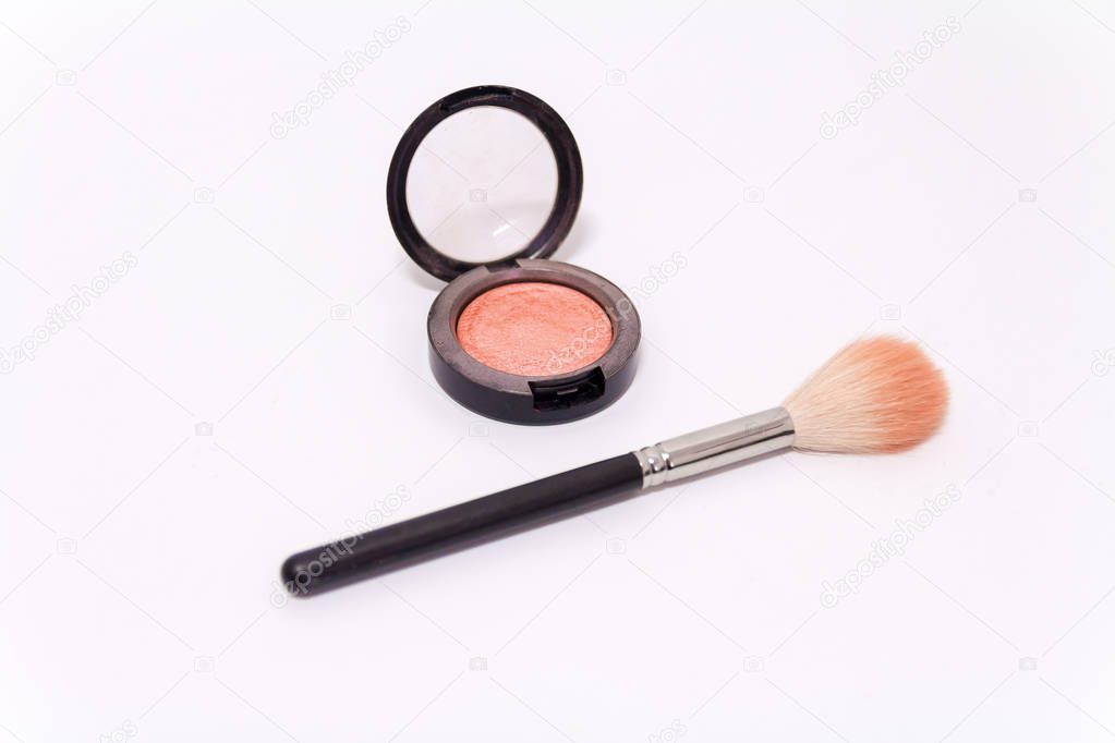 Close up of makeup brush and blush box isolated on white backgro