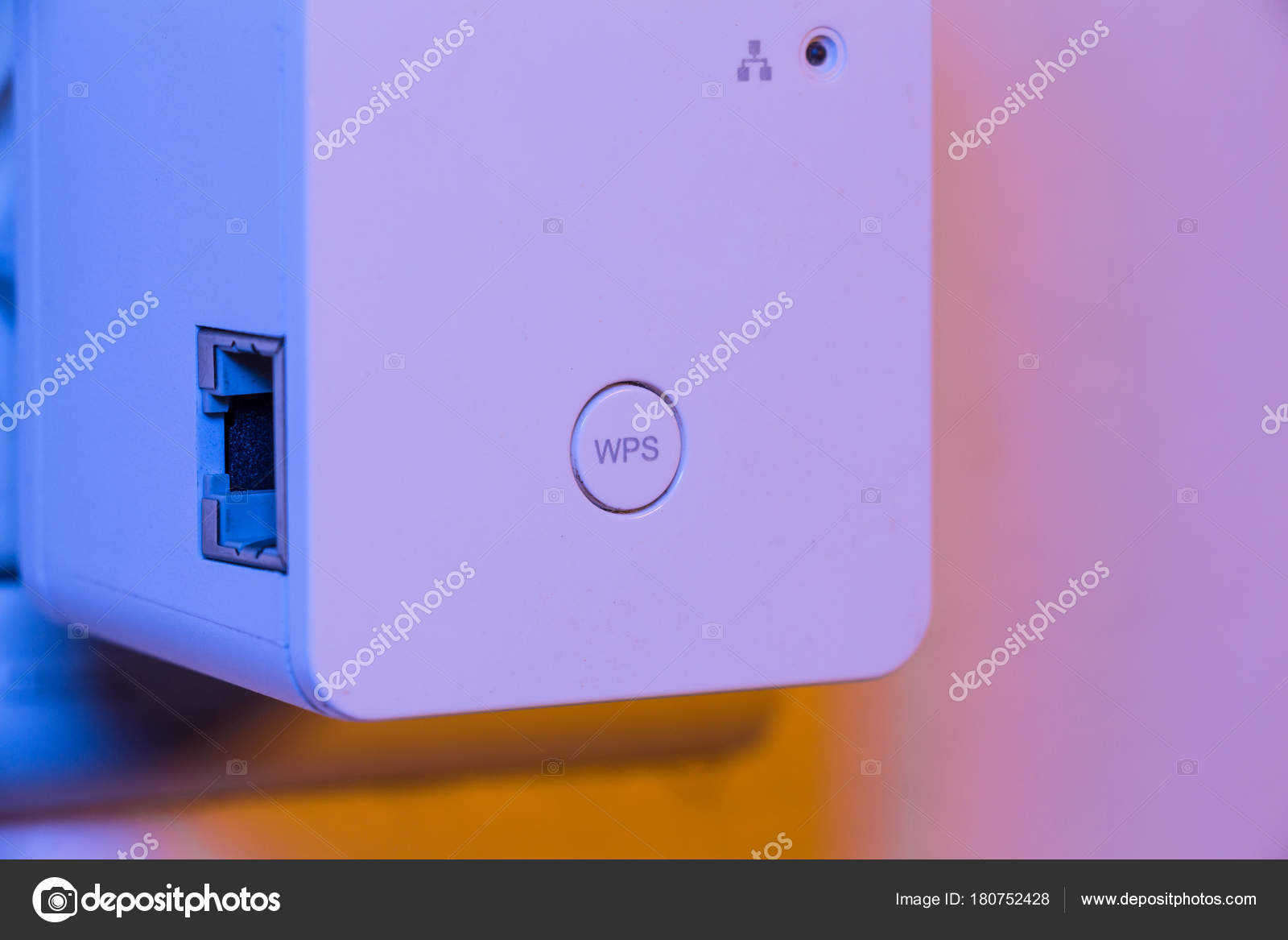 WiFi repeater in electrical socket on the wall Stock Photo by