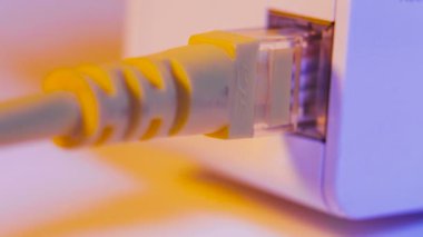 Makro yakın çekim WiFi extender ethernet kablosu ile duvardaki elektrik yuvasında takılı. Ev ya da ofis kablosuz ağ genişletmek için yardım erişim noktası modunda cihazdır.
