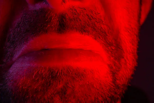 Macro closeup on man lips with sad facial expression