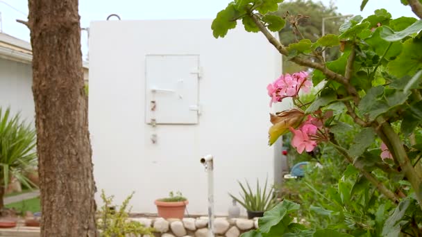 Mobile bomb shelter inside a home garden in Israel. This is an extra Fortified Room that helps the house residents to be protected from rocket fire attacks. It called Migunit" or "Merkhav Mugan"." — Stock Footage Mobile Bomb Shelter Home Garden Israel Extra Fortified Room Helps Royalty Free Stock Footage