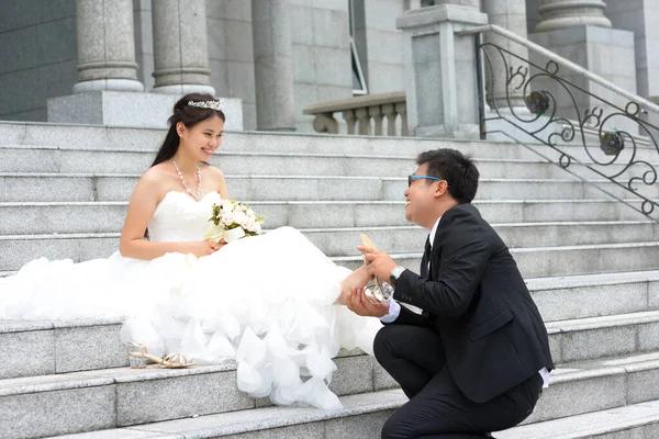 Asiatisk Brudgum Hjälper Sin Brud Att Bära Sko — Stockfoto