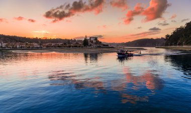 Fishing boat returning to port Ribadesella clipart