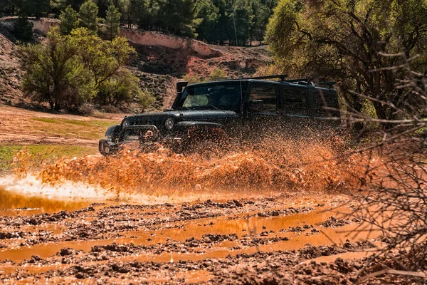 All-terrain vehicle passing through an area of mud