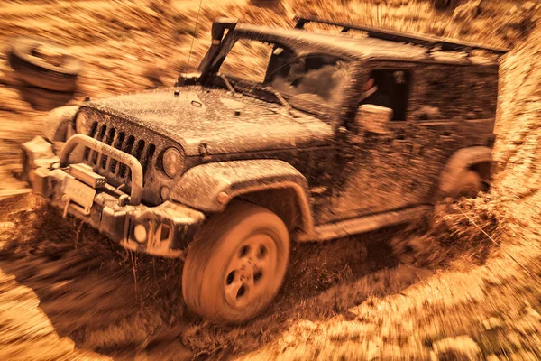 All-terrain vehicle passing through an area of mud — Stock Photo, Image