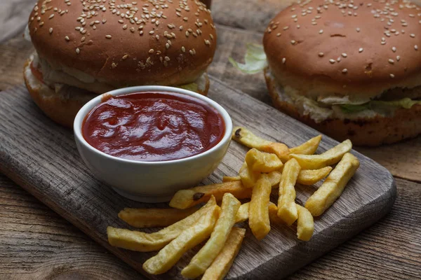 Fresh home-made hamburger served on wood. Wooden background. Tasty hamburger with chicken. View from above.