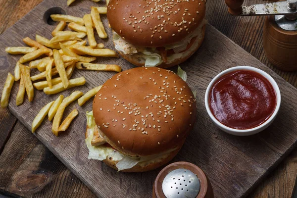 Beef burgers and french fries on wooden background with blank sp — Stock Photo, Image