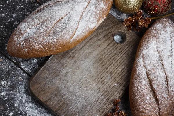 Хлеб на деревянном фоне с мукой. Вид сверху. Коллаж с бутербродами, хлебом, рождественскими игрушками. Рекламный хлеб . — стоковое фото