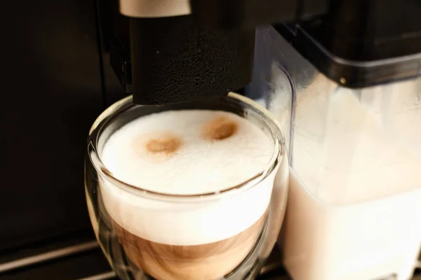 Home coffee machine. Making a cappuccino in a coffee machine. Fresh coffee.