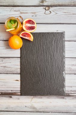 Fresh orange on a wooden background. Juice in a jar. Summer drink. Orange on a wooden background