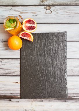 Fresh orange on a wooden background. Juice in a jar. Summer drink. Orange on a wooden background