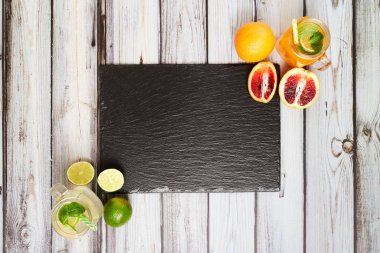 Summer drinks. Fresh freshes on a slate board. View from above. Orange, lemon and strawberry fresh.