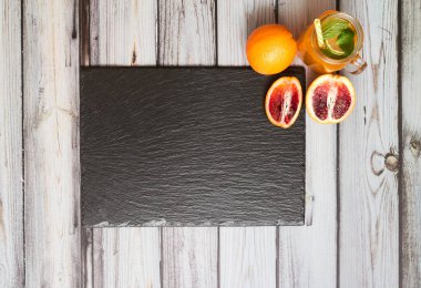 Fresh orange on a wooden background. Juice in a jar. Summer drink. Orange on a wooden background