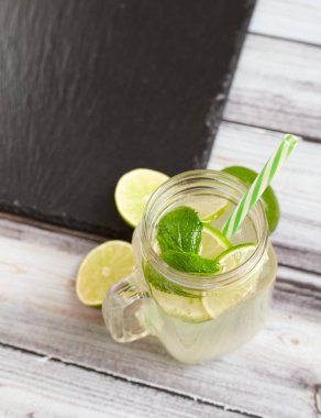 Lemonade on a wooden background. Summer drink.