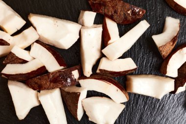 Coconut pieces on a dark background.