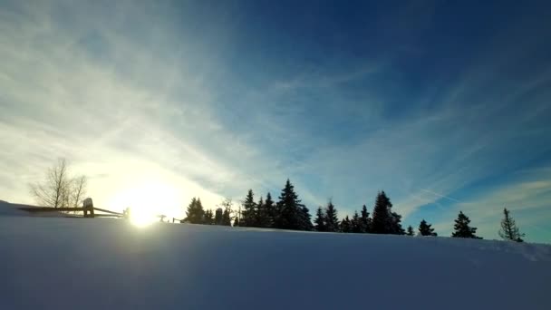 寒い冬の日に小さな村の上に雲 村の下の雪の上のいくつかのトレイル — ストック動画