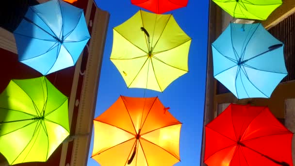 Opened Colorful Bold Colored Umbrellas Hanging Wires Street — Vídeo de Stock