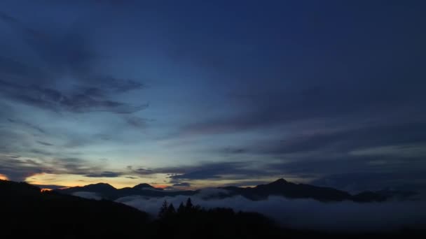 集中的な夕日 大胆な色 霧と霧の谷 遠くの山々 自然の中で平和 上記の壮大な空 一日が終わる まもなく始まる — ストック動画