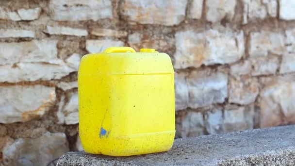 Big Yellow Canister Bench Stoned Wall Water Oil Fuel Just — Αρχείο Βίντεο